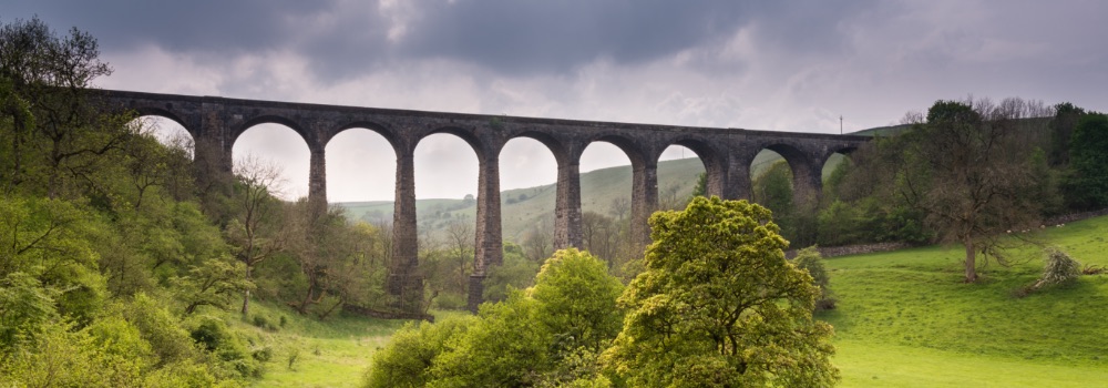 Panoramic photo of bridge spanning picturesque valley