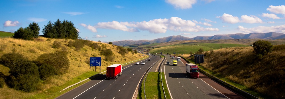 Panoramic photo of a motorway with hills in the background