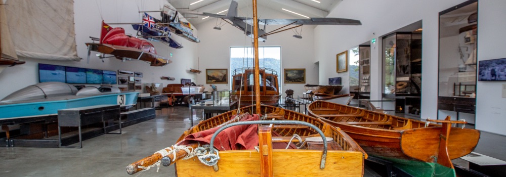 Photo of interior of a museum with boats, planes and canvases