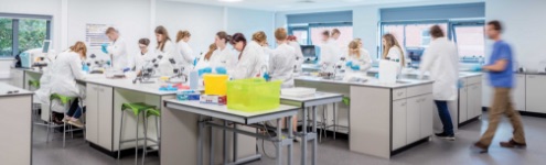 Wide motion photo of students in a science laboratory